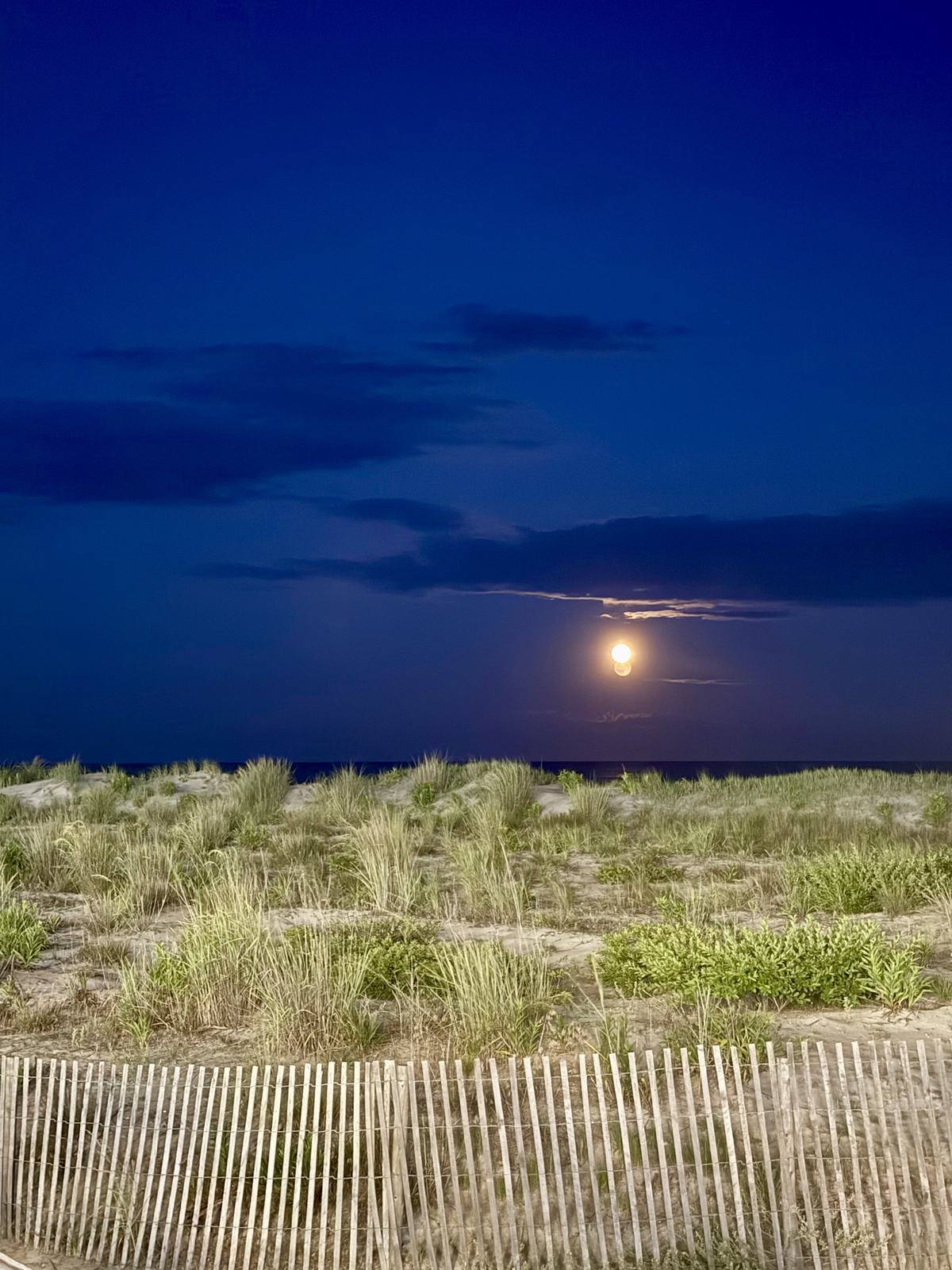 Moonlit clouds above a beach
